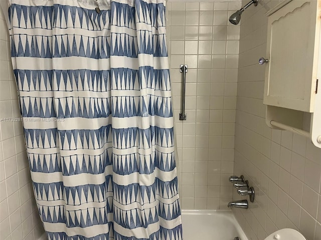 bathroom with shower / bathtub combination with curtain