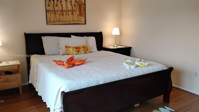 bedroom with dark wood-type flooring