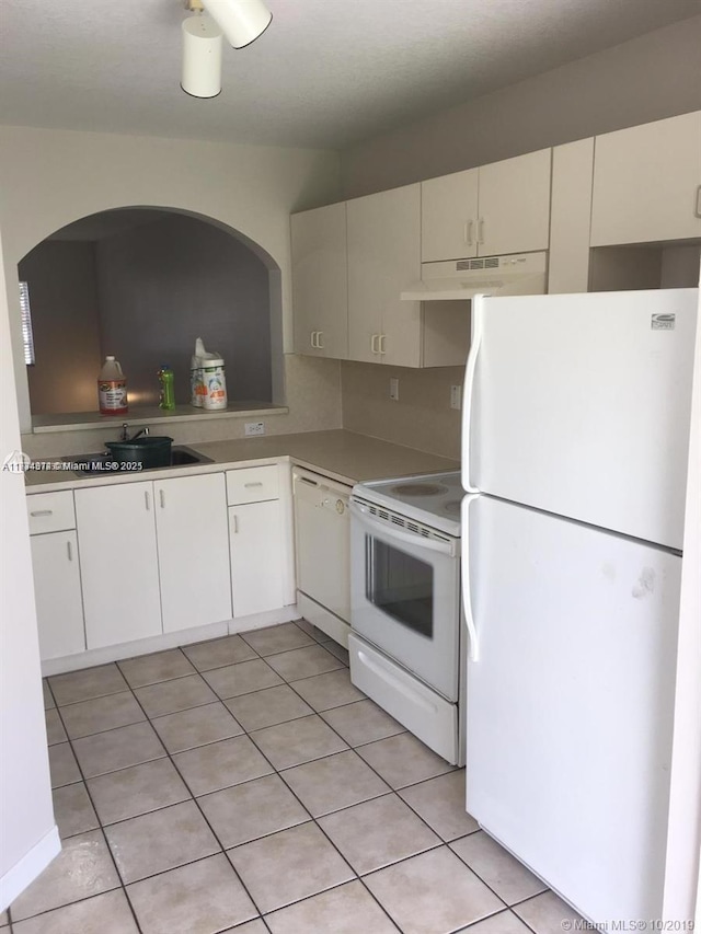 kitchen with white cabinetry, white appliances, sink, and light tile patterned floors