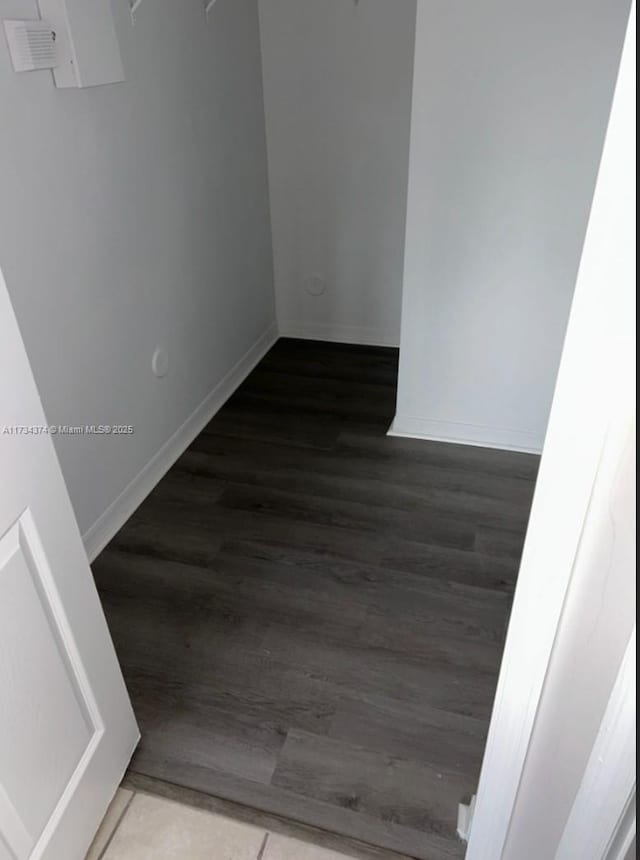 empty room featuring dark wood-type flooring