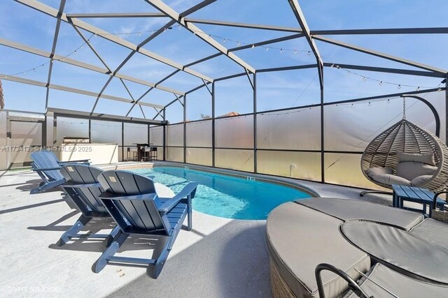 view of pool featuring a patio area and glass enclosure