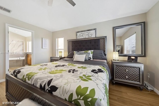 bedroom featuring dark hardwood / wood-style floors, ceiling fan, and connected bathroom