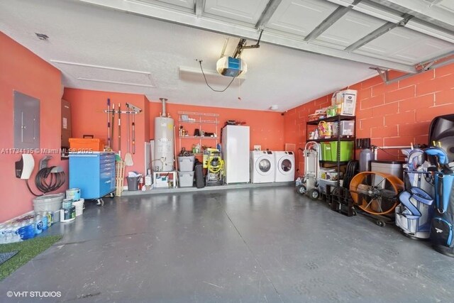 garage featuring a garage door opener, gas water heater, white refrigerator, electric panel, and washer and clothes dryer