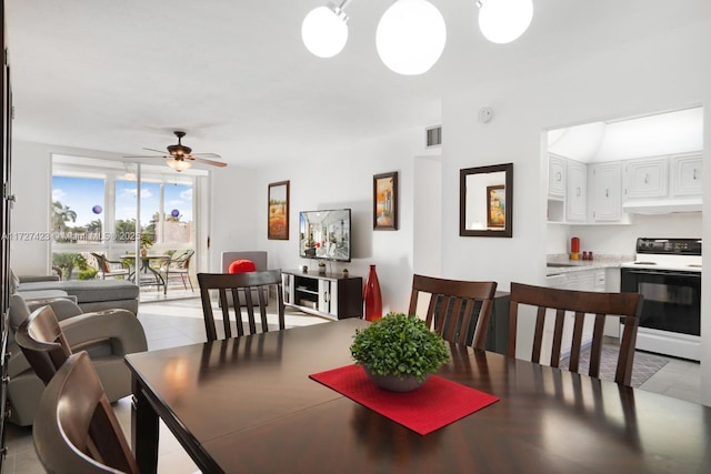 dining area featuring light tile patterned floors and ceiling fan