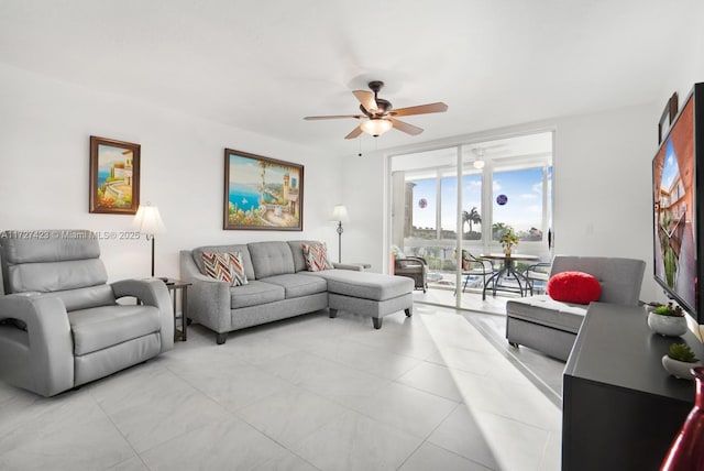 tiled living room with floor to ceiling windows and ceiling fan