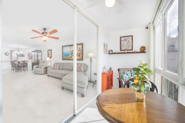 dining space with ceiling fan with notable chandelier