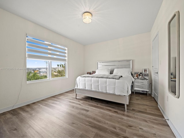 bedroom with dark hardwood / wood-style floors