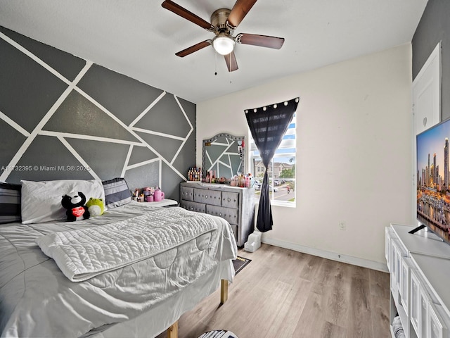 bedroom with light hardwood / wood-style flooring and ceiling fan