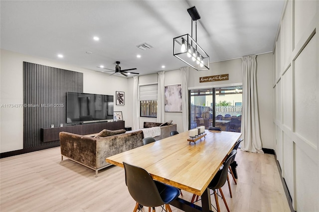 dining room with ceiling fan and light hardwood / wood-style floors