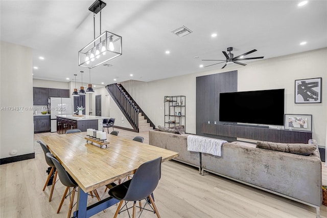 dining room featuring ceiling fan and light wood-type flooring