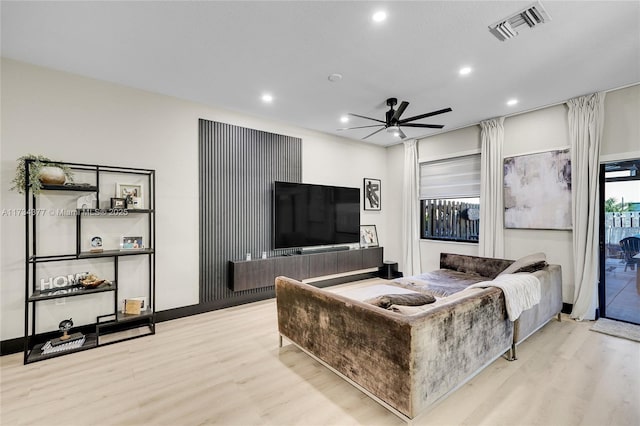 living room featuring ceiling fan and light wood-type flooring