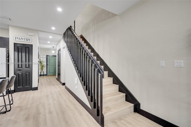 stairs with hardwood / wood-style flooring