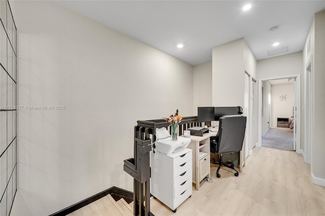 office area with light hardwood / wood-style floors