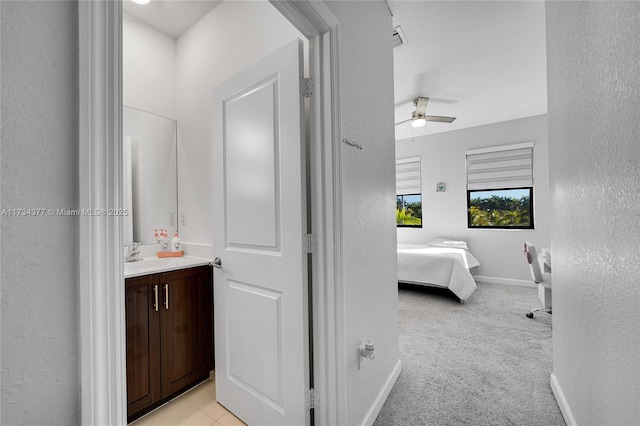 bathroom with ceiling fan and vanity