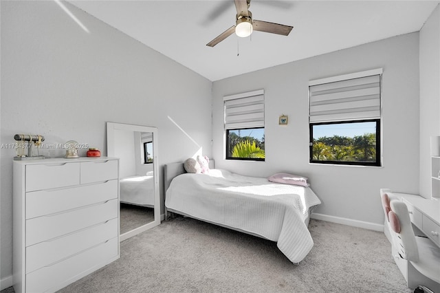 carpeted bedroom with vaulted ceiling and ceiling fan