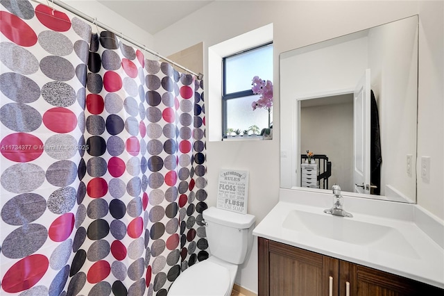 bathroom featuring vanity and toilet