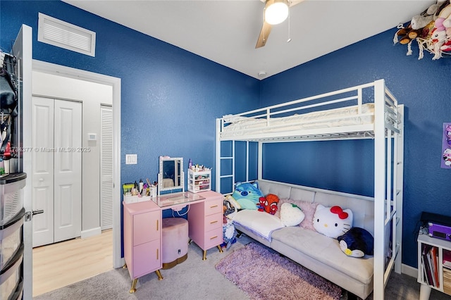 carpeted bedroom featuring a closet and ceiling fan