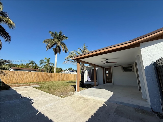 view of patio featuring ceiling fan