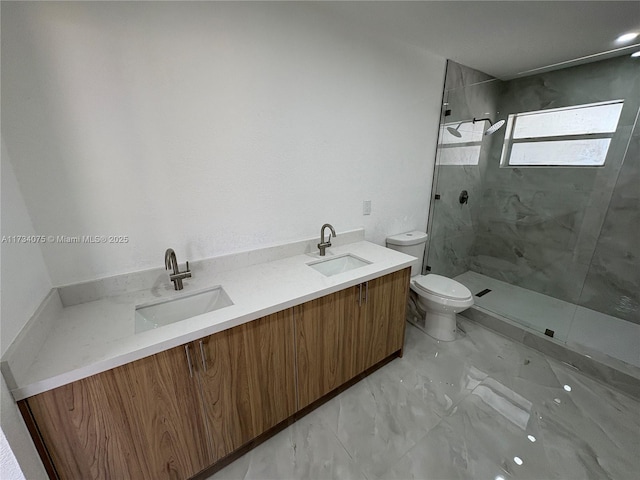 bathroom featuring vanity, a tile shower, and toilet