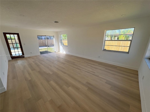 empty room with light hardwood / wood-style flooring