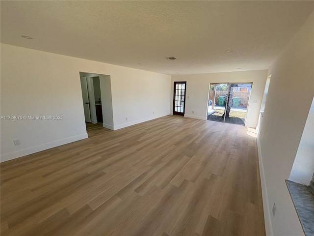 spare room featuring wood-type flooring