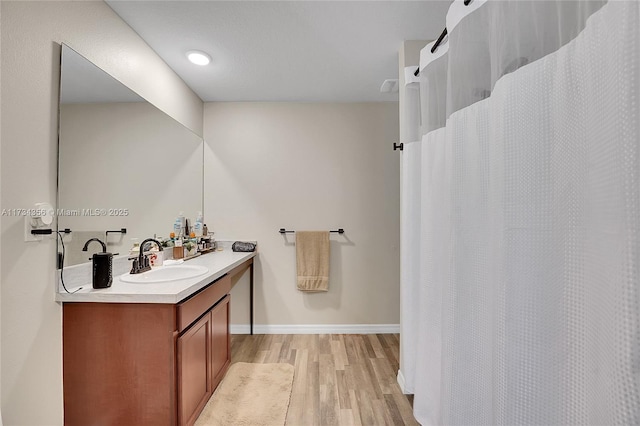 bathroom with wood-type flooring and vanity