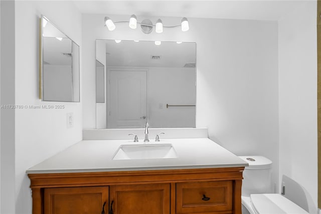 bathroom with vanity and toilet