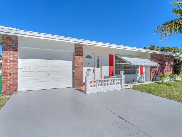 ranch-style home featuring a garage and a front lawn