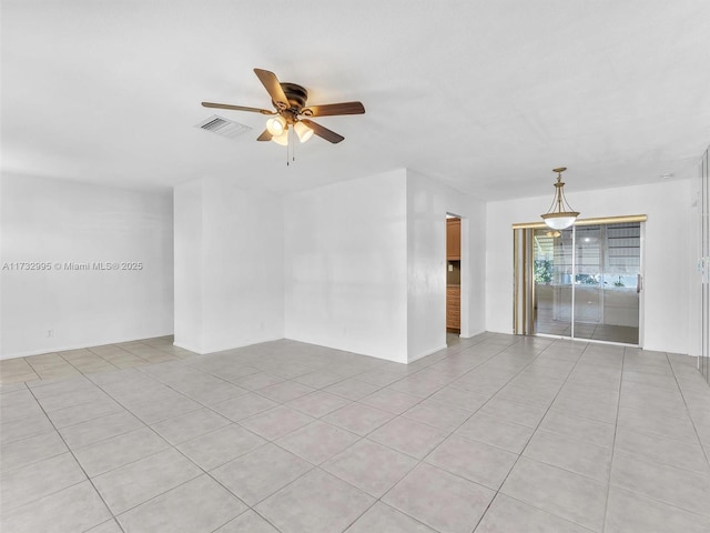 spare room with ceiling fan and light tile patterned flooring