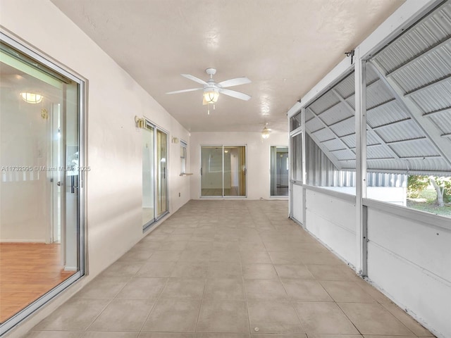 hall featuring light tile patterned flooring