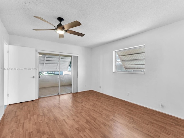 unfurnished bedroom featuring ceiling fan, wood-type flooring, and a textured ceiling