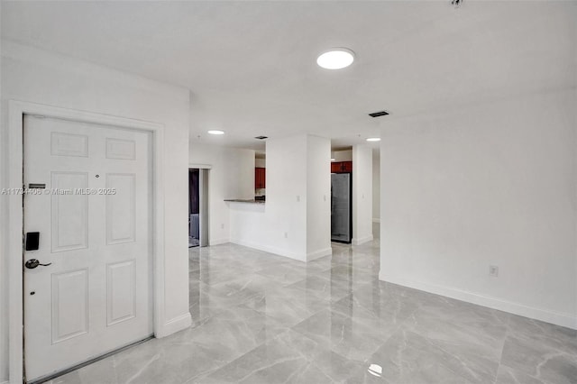 spare room featuring marble finish floor, visible vents, and baseboards