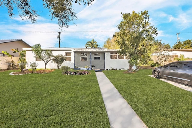 ranch-style house featuring a front lawn