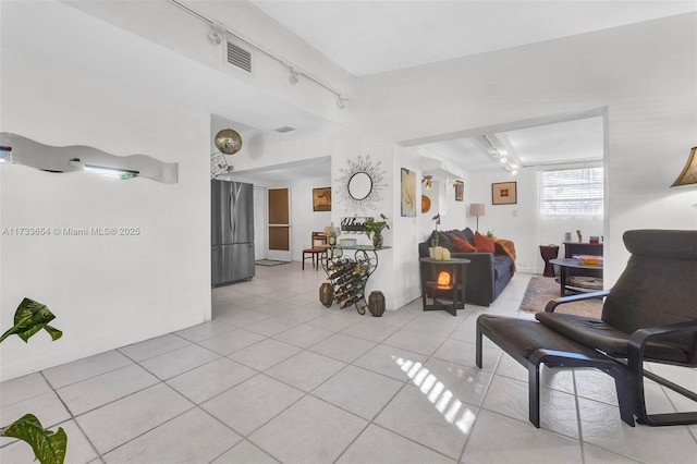 tiled living room featuring rail lighting