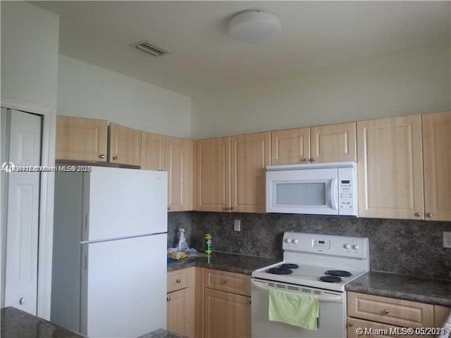 kitchen featuring white appliances, tasteful backsplash, and light brown cabinets