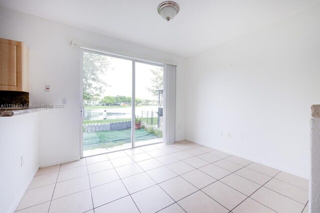2818 SE 16th Ave Unit 118, Homestead, FL 33035 - unfurnished dining area with a water view and light tile patterned flooring