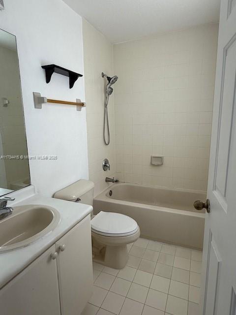 bathroom featuring tile patterned flooring, bathtub / shower combination, vanity, and toilet