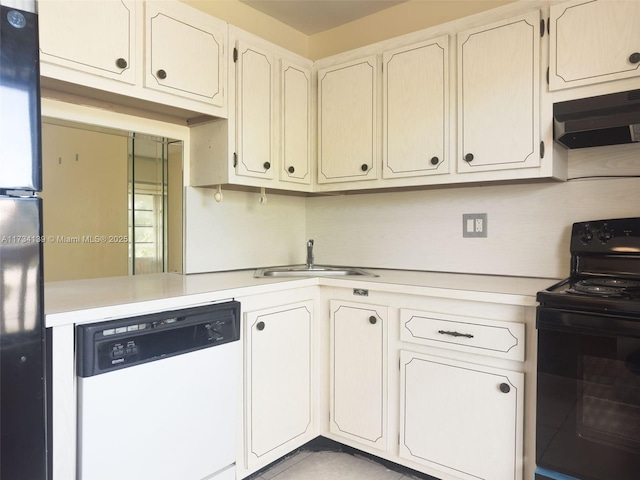 kitchen featuring white cabinetry, sink, and black appliances