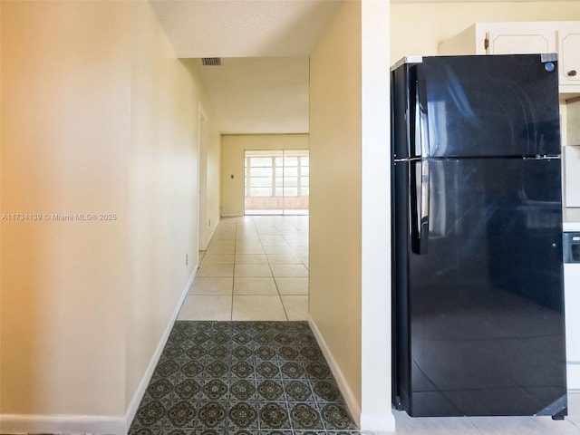 hallway with light tile patterned floors