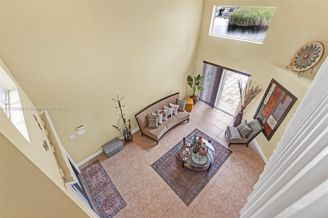 living room featuring a high ceiling and light tile patterned flooring