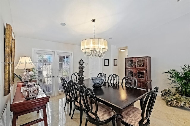 dining room with light tile patterned floors, an inviting chandelier, and french doors