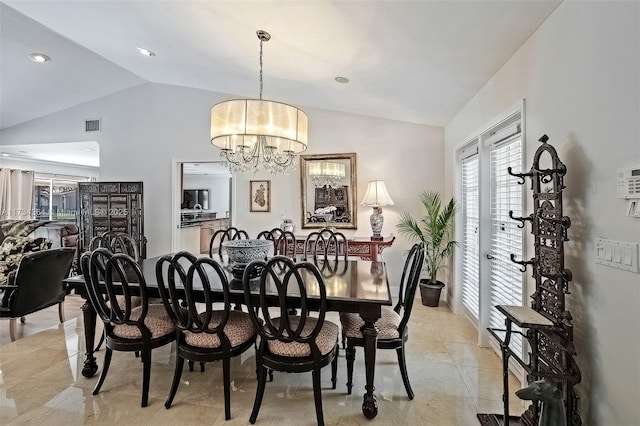 dining room with vaulted ceiling and a chandelier