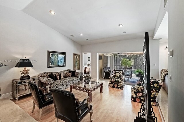 living room featuring vaulted ceiling and light wood-type flooring