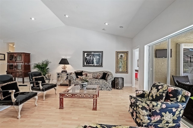 sitting room with vaulted ceiling and light hardwood / wood-style floors