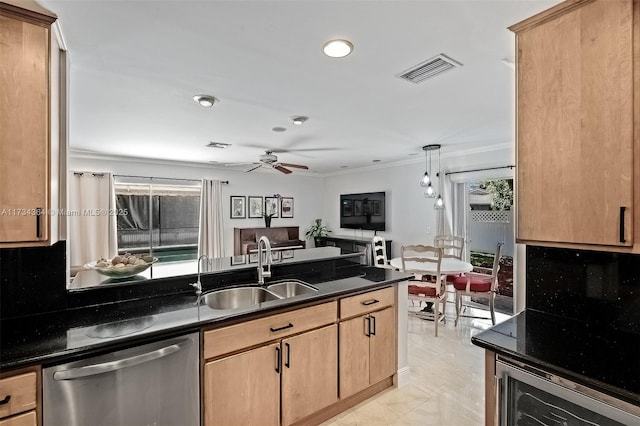 kitchen featuring pendant lighting, dishwasher, sink, decorative backsplash, and dark stone counters