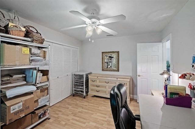 home office featuring ceiling fan and light hardwood / wood-style flooring