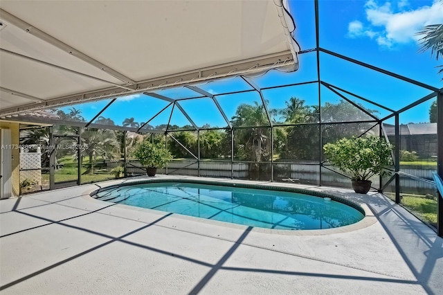 view of swimming pool featuring a lanai and a patio area