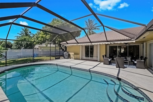 view of swimming pool with an outdoor living space, a patio, and glass enclosure