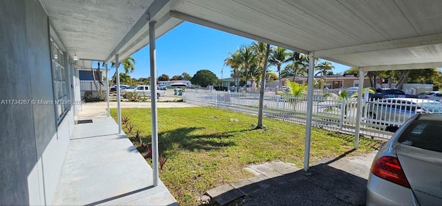 exterior space with a carport and a yard