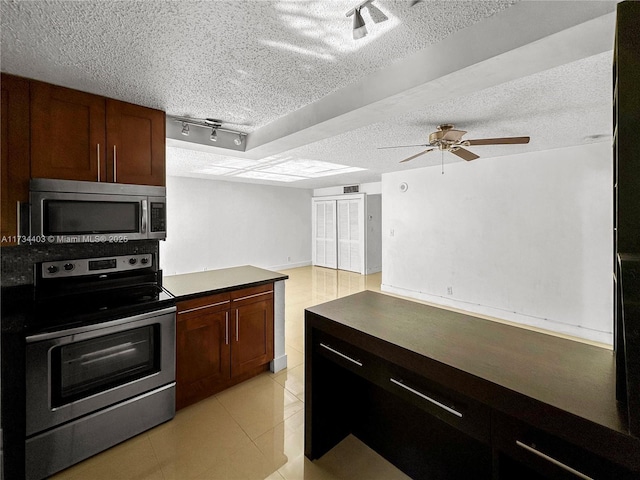 kitchen with ceiling fan, stainless steel appliances, and track lighting